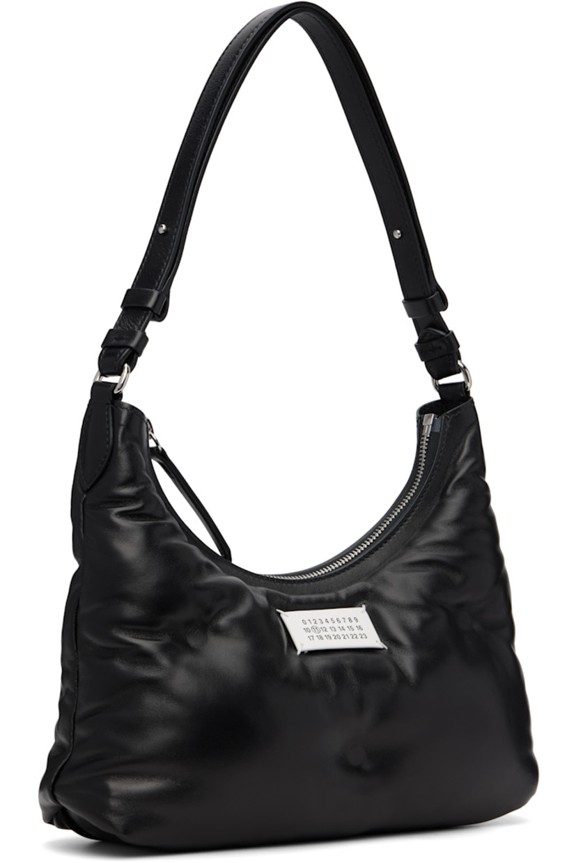 Buffed nappa lambskin shoulder bag.

· Adjustable shoulder strap
· Logo patch at face
· Zip closure
· Zip pocket at interior 
· Silver-tone hardware
· H8.5” x W10.5” x D3”

Supplier color: Black