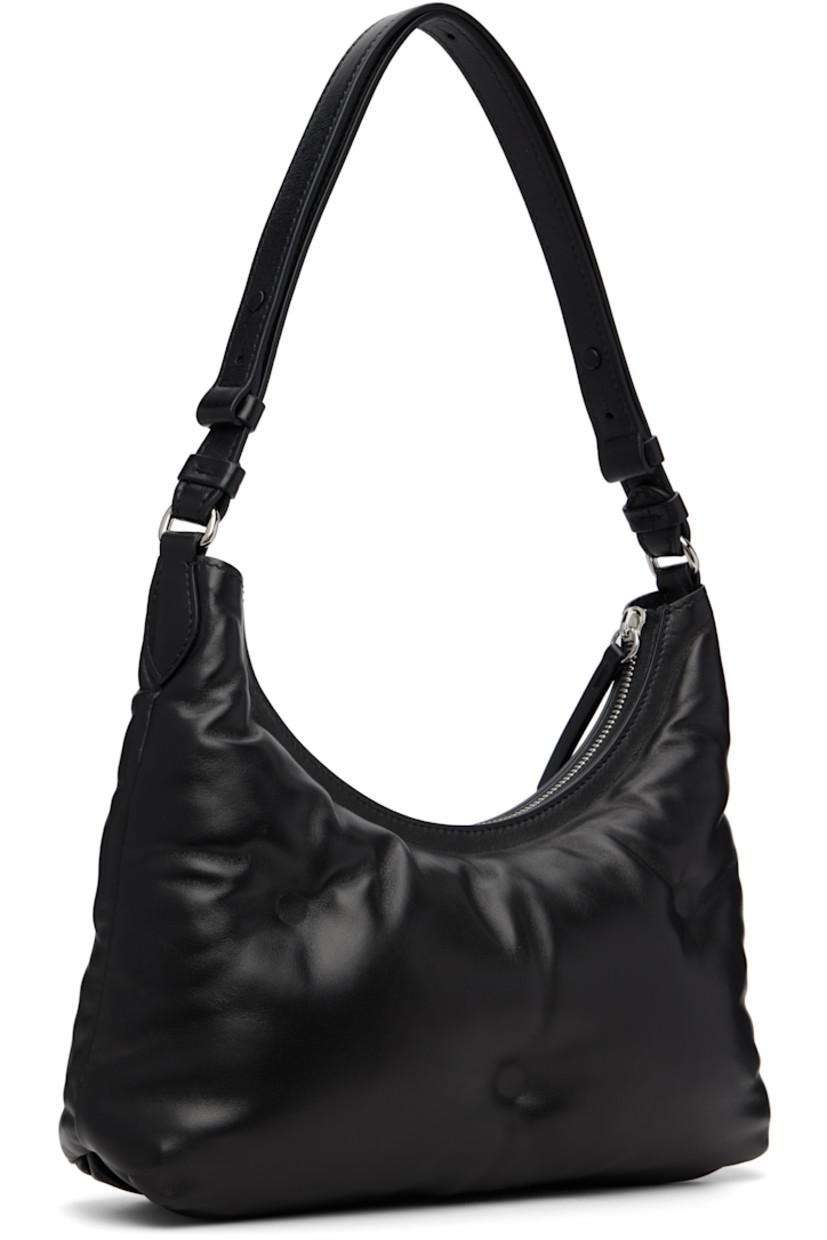 Buffed nappa lambskin shoulder bag.

· Adjustable shoulder strap
· Logo patch at face
· Zip closure
· Zip pocket at interior 
· Silver-tone hardware
· H8.5” x W10.5” x D3”

Supplier color: Black