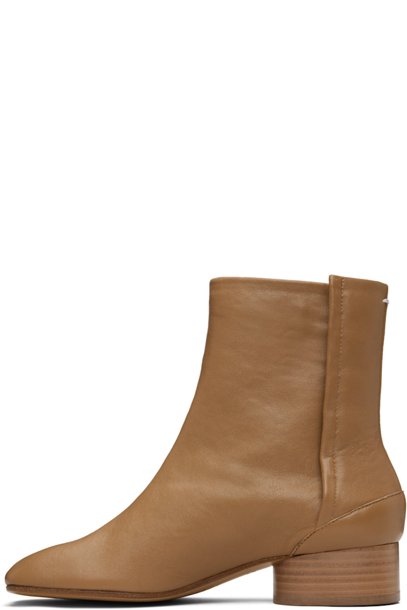 Ankle-high buffed lambskin boots.

· Square cleft toe
· Hook-eye closure at inner side
· White stitching at heel collar
· Stacked cylindrical heel with rubber injection
· Calfskin sole
· Heel: H1.25"

Supplier color: Nude