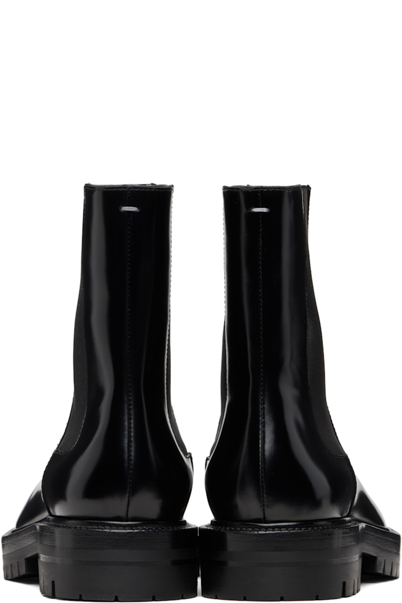 Ankle-high polished calfskin Chelsea boots.

· Square cleft toe
· Elasticized gusset at sides
· Signature white stitch at heel collar
· Buffed lambskin lining
· Stacked leather heel and midsole
· Lugged rubber sole
· Heel: H1.25"

Supplier color: Black