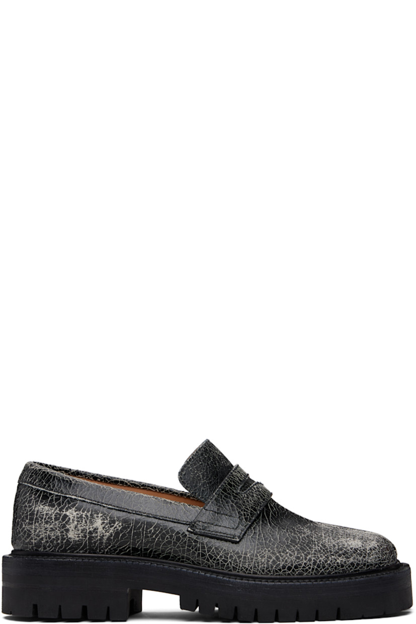 Cracked calfskin loafers.

· Square cleft toe
· Strap with cutout at vamp
· White stitching at heel collar
· Buffed sheepskin lining
· Serrated edge at welt
· Treaded rubber sole

Supplier color: Black/White