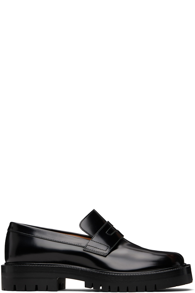Polished calfskin loafers.

· Square cleft toe
· Strap with cutout at vamp
· Signature white stitch at heel collar
· Buffed lambskin lining
· Stacked calfskin and rubber midsole
· Lugged rubber sole
· Heel: H1.25"

Supplier color: Black