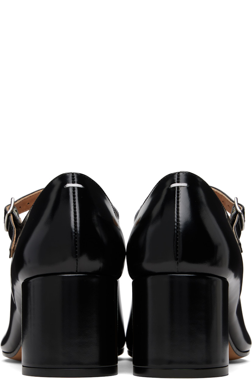 Polished calfskin Mary Jane-style heels.

· Square cleft toe
· Pin-buckle strap at vamp
· White stitching at heel collar
· Buffed lambskin lining
· Covered block heel with rubber injection
· Calfskin sole
· Heel: H2.25"

Supplier color: Black