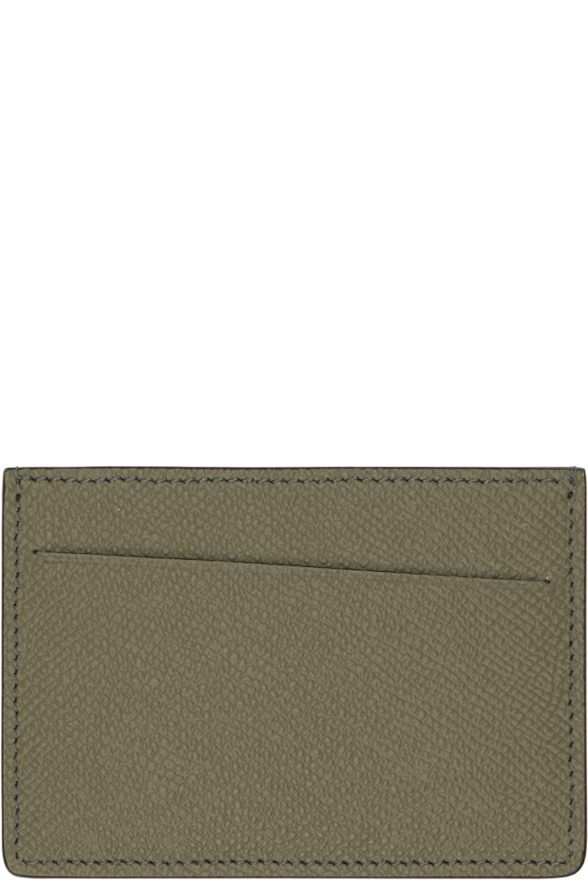 Saffiano and buffed calfskin card holder.

· White stitching at back face 
· Two card slots
· Central note slot 
· Canvas lining 
· H3" x W4"

Supplier color: Khaki
