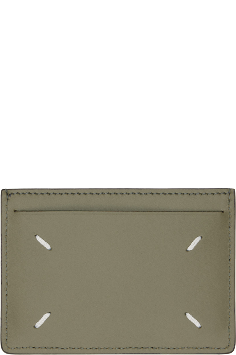 Saffiano and buffed calfskin card holder.

· White stitching at back face 
· Two card slots
· Central note slot 
· Canvas lining 
· H3" x W4"

Supplier color: Khaki