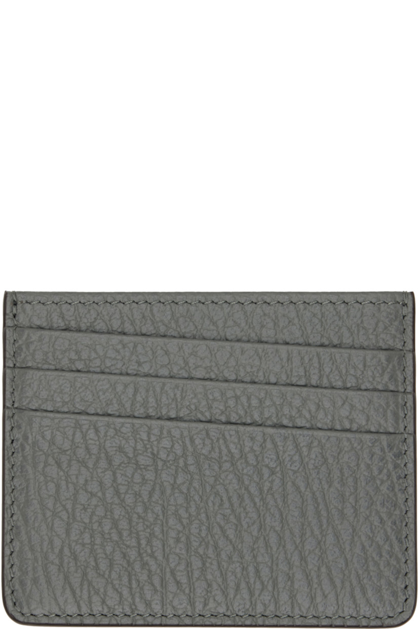 Pebble-grained calfskin card holder. 

· White stitching at back face
· Five card slots
· Central note slot
· Canvas lining
· H3.25" x W4"

Supplier color: Caillou