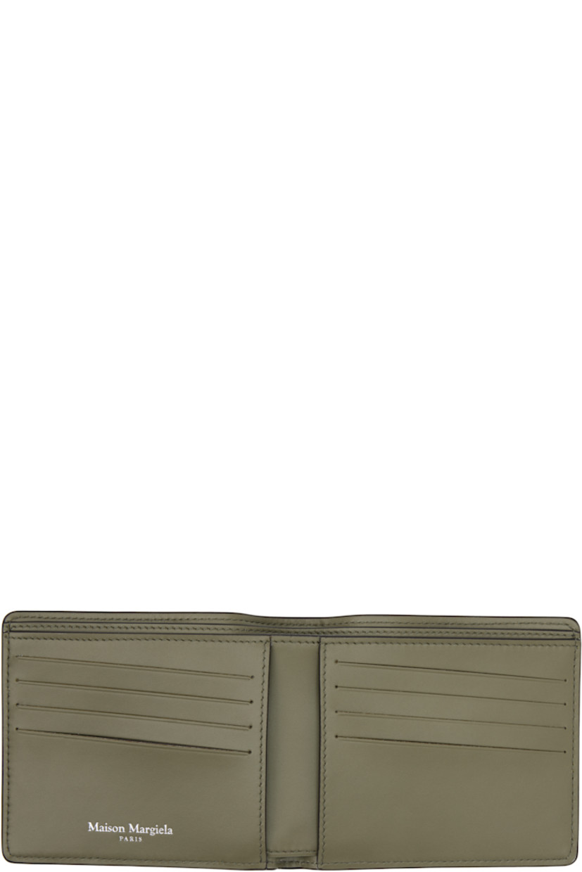 Pebble-grained calfskin bifold wallet.

· White stitching at face 
· Eight card slots and two patch pockets at interior 
· Two note slots 
· Canvas lining 
· H3.75" x W4.25" x D0.75"

Supplier color: Khaki
