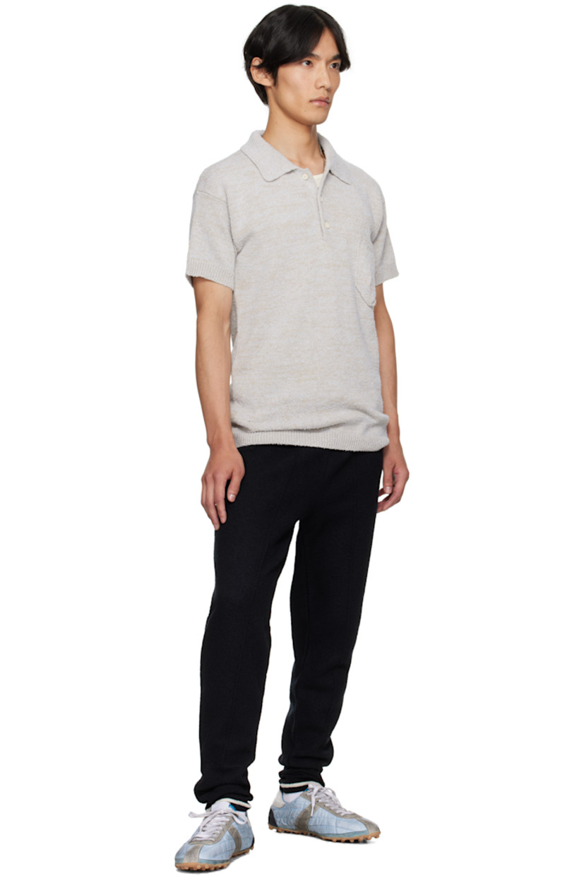 Wool melton track pants.

· Tapered leg
· Drawstring at elasticized waistband
· Single-pocket styling
· Pinched seam at legs
· Zip vent at striped rib-knit cuffs
· White stitching at back

Supplier color: Black/Off white