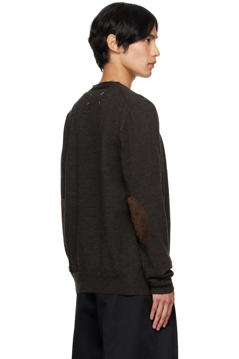 Knit wool cardigan.

· Rib-knit Y-neck, hem, and cuffs
· Button closure
· Suede elbow patches
· White stitching at back collar

Supplier color: Dark brown