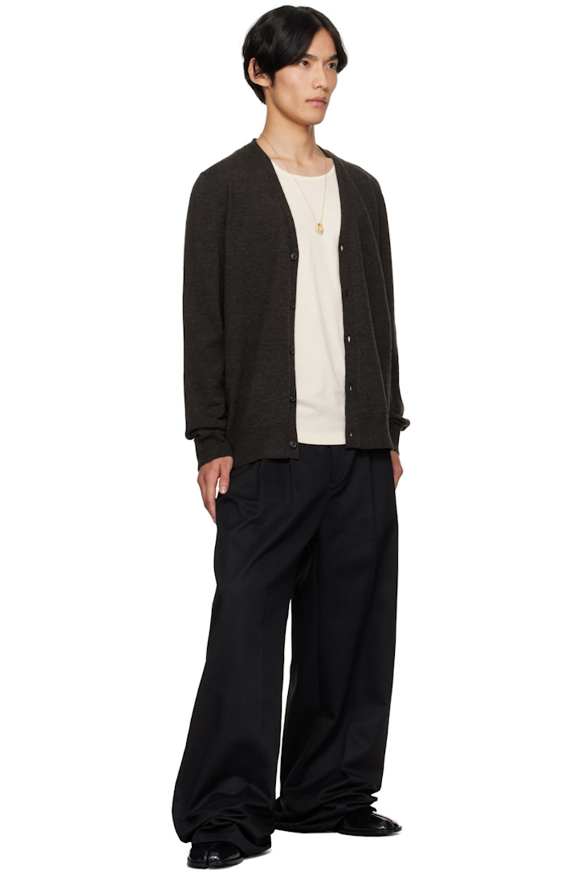 Knit wool cardigan.

· Rib-knit Y-neck, hem, and cuffs
· Button closure
· Suede elbow patches
· White stitching at back collar

Supplier color: Dark brown