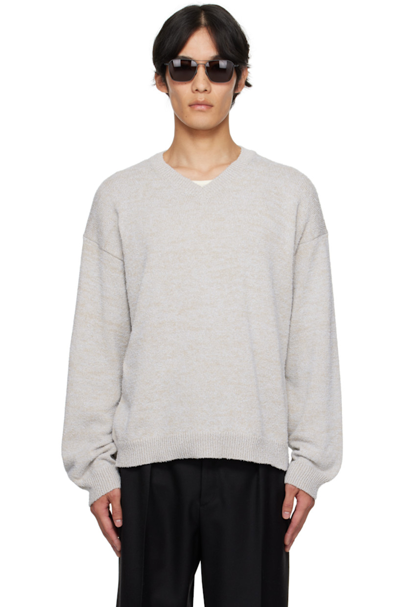 Knit cotton-blend sweater.

· Subtle pilling throughout
· Rib-knit V-neck, hem, and cuffs
· Dropped shoulders
· White stitching at back collar

Supplier color: Ice blue/Beige