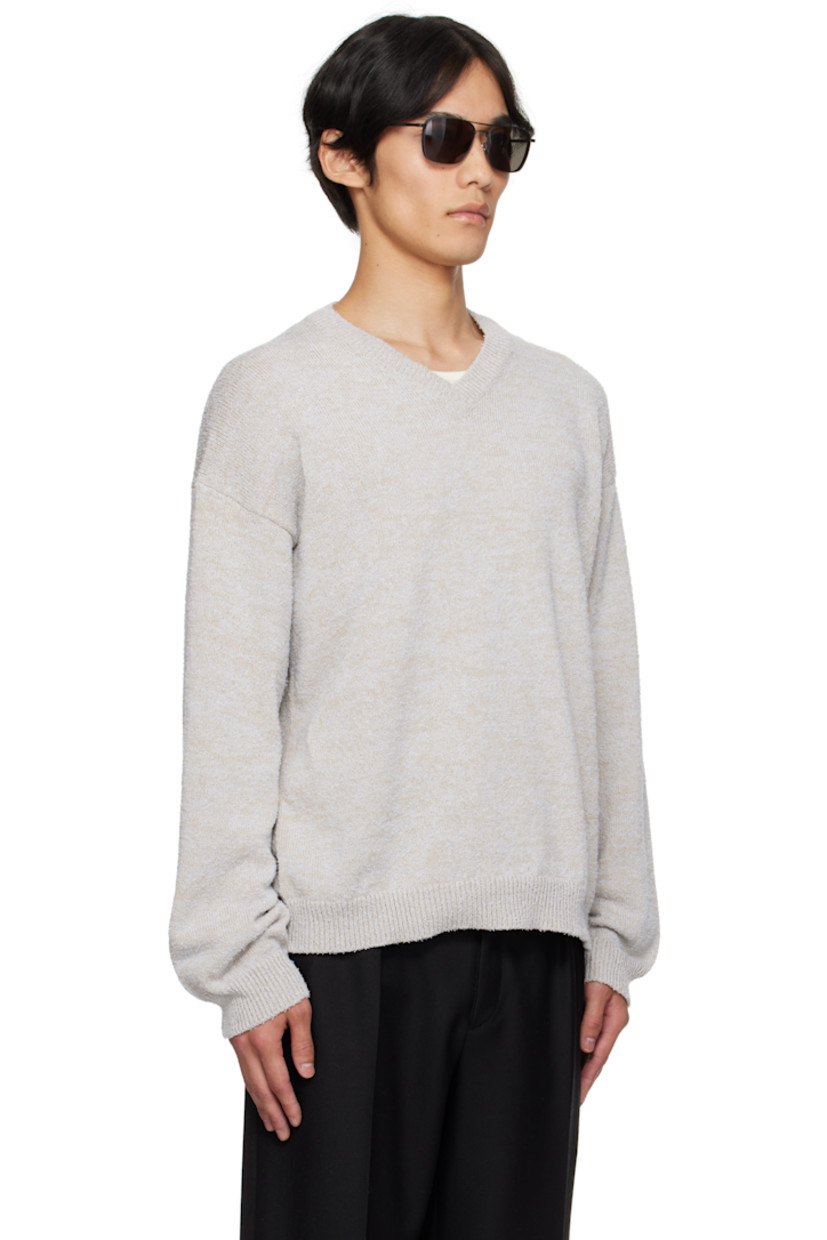 Knit cotton-blend sweater.

· Subtle pilling throughout
· Rib-knit V-neck, hem, and cuffs
· Dropped shoulders
· White stitching at back collar

Supplier color: Ice blue/Beige