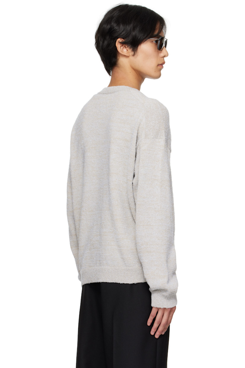 Knit cotton-blend sweater.

· Subtle pilling throughout
· Rib-knit V-neck, hem, and cuffs
· Dropped shoulders
· White stitching at back collar

Supplier color: Ice blue/Beige