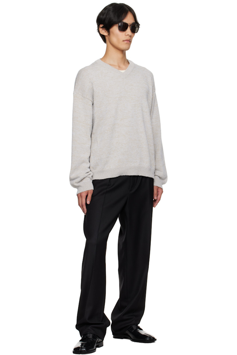 Knit cotton-blend sweater.

· Subtle pilling throughout
· Rib-knit V-neck, hem, and cuffs
· Dropped shoulders
· White stitching at back collar

Supplier color: Ice blue/Beige