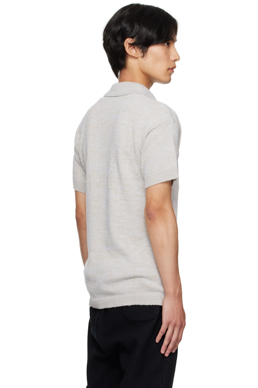 Knit cotton- and wool-blend polo.

· Subtle pilling throughout
· Rib-knit spread collar, hem, and cuffs
· Three-button placket
· Patch pocket at chest
· White stitching at back collar

Supplier color: Ice blue/Beige