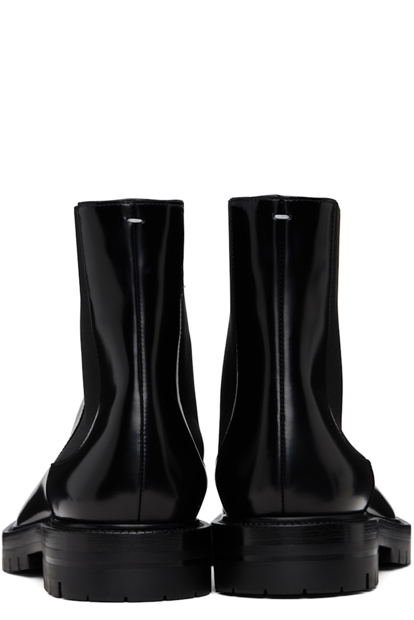 Ankle-high polished calfskin Chelsea boots.

· Square cleft toe
· Elasticized gusset at sides
· White stitching at heel collar
· Buffed lambskin lining
· Serrated edge at welt
· Treaded rubber sole

Supplier color: Black
