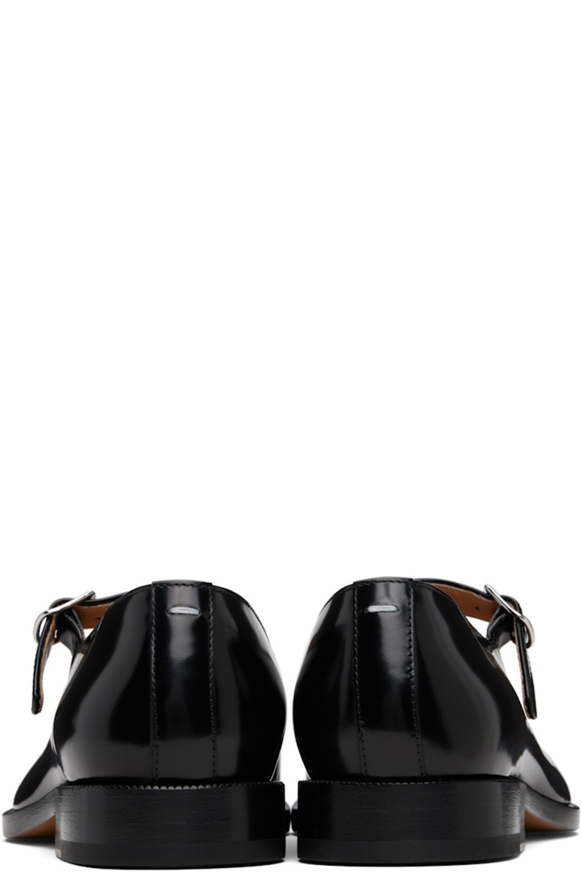 Polished calfskin Mary Jane-style loafers.

· Square cleft toe
· Pin-buckle strap at vamp
· White stitching at heel collar
· Buffed sheepskin lining
· Serrated edge at welt
· Stacked leather heel with rubber injection
· Calfskin sole

Supplier color: Black