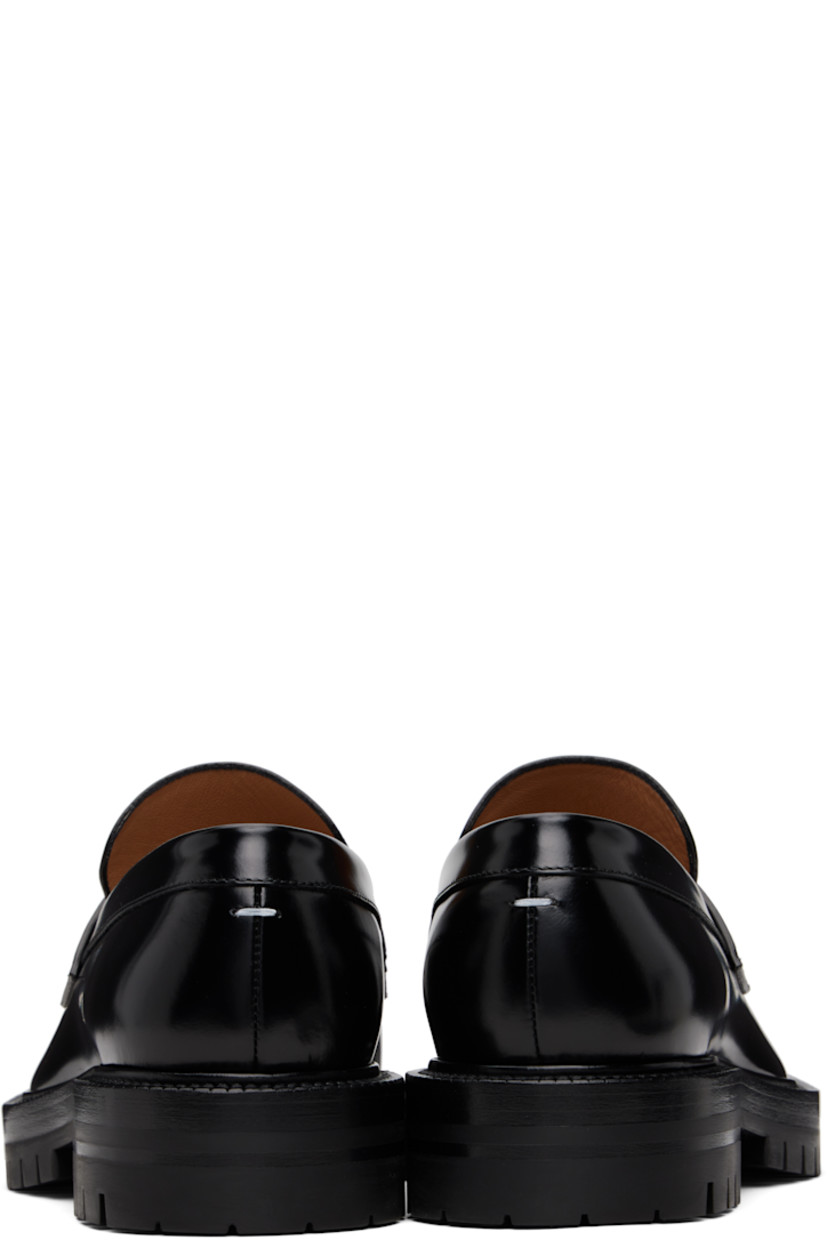Polished calfskin loafers.

· Square cleft toe
· Strap with cutout at vamp
· White stitching at heel collar
· Buffed lambskin lining
· Serrated edge at welt
· Treaded rubber sole

Supplier color: Black