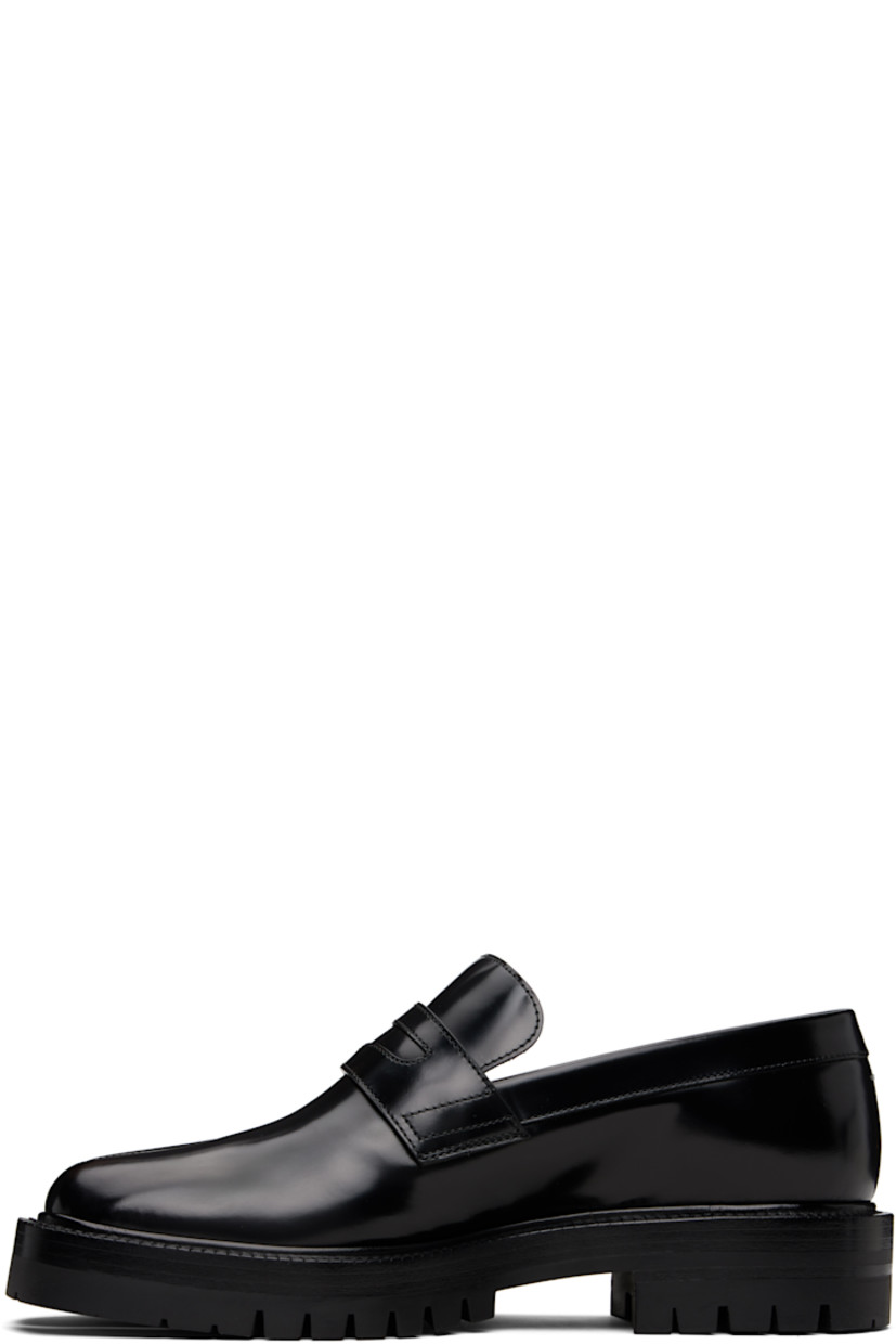 Polished calfskin loafers.

· Square cleft toe
· Strap with cutout at vamp
· White stitching at heel collar
· Buffed lambskin lining
· Serrated edge at welt
· Treaded rubber sole

Supplier color: Black