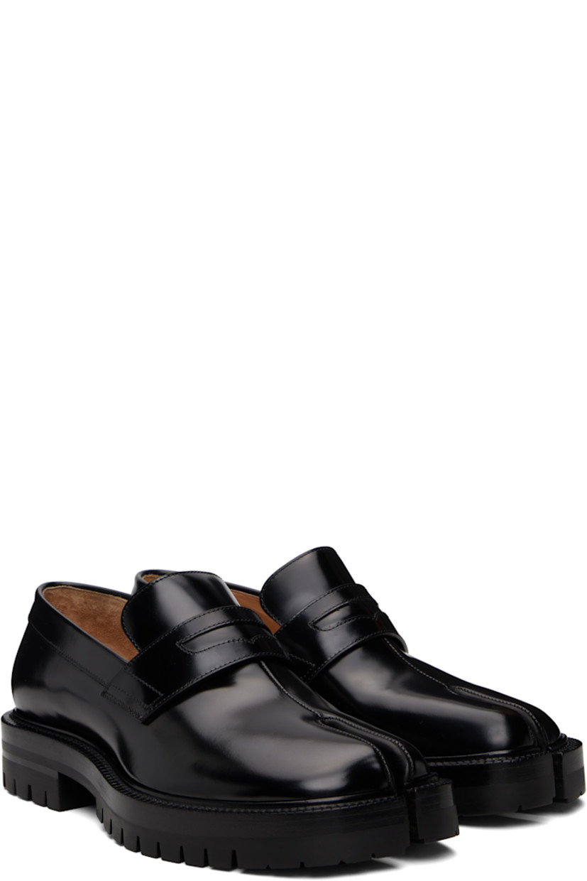 Polished calfskin loafers.

· Square cleft toe
· Strap with cutout at vamp
· White stitching at heel collar
· Buffed lambskin lining
· Serrated edge at welt
· Treaded rubber sole

Supplier color: Black