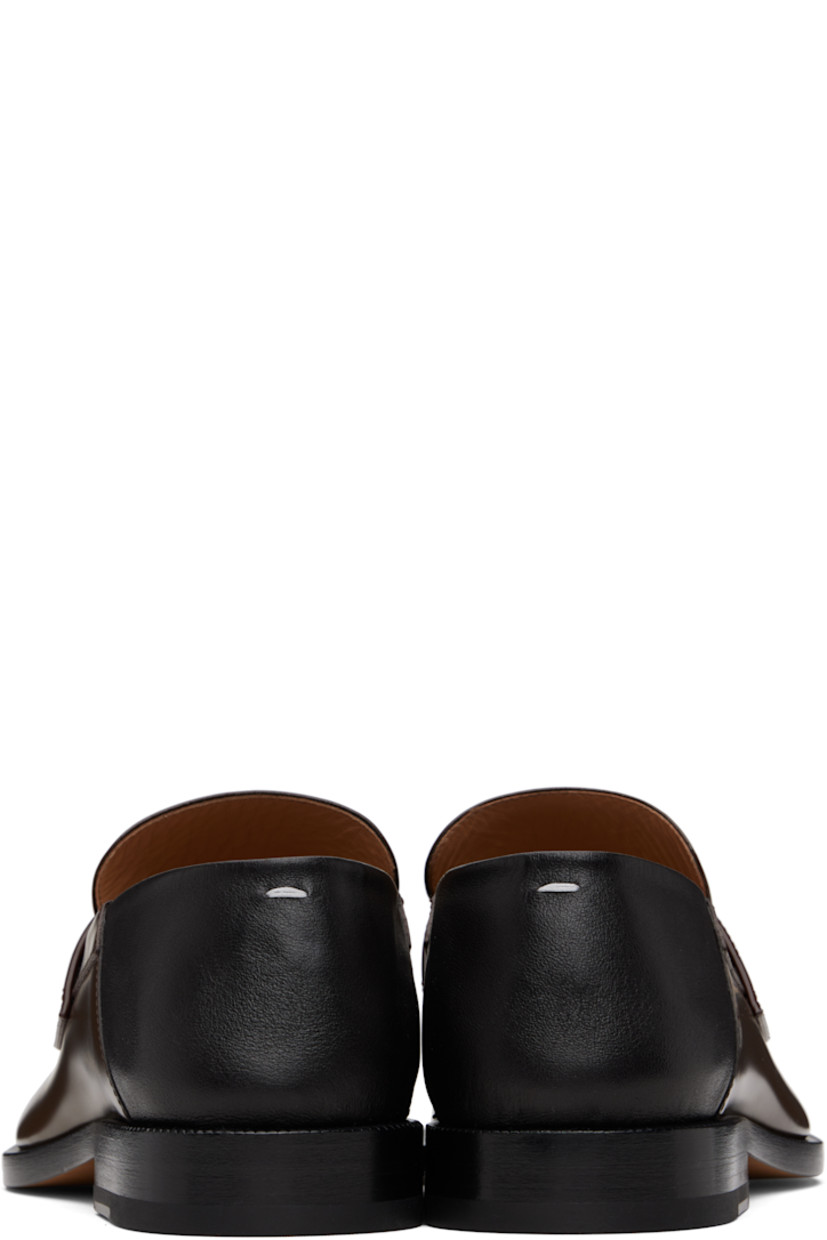 Buffed calfskin loafers.

· Square cleft toe
· Strap with cutout at vamp
· White stitching at heel collar
· Collapsible heel counter
· Serrated edge at welt
· Stacked leather heel with rubber injection
· Calfskin sole

Supplier color: Wood