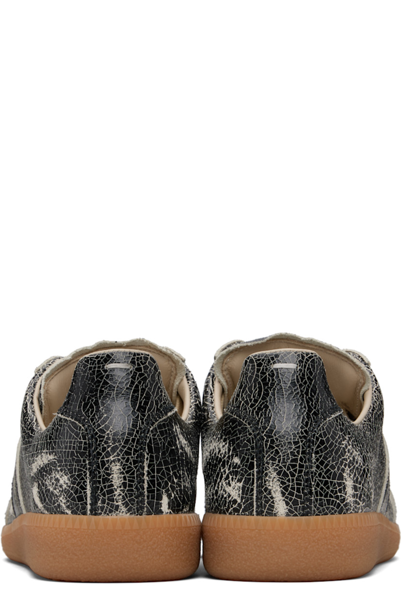 Low-top cracked calfskin sneakers.

· Lace-up closure
· Logo patch at padded tongue
· Padded collar
· White stitching at heel collar
· Plain-woven lining
· Treaded rubber sole

Supplier color: Black/White