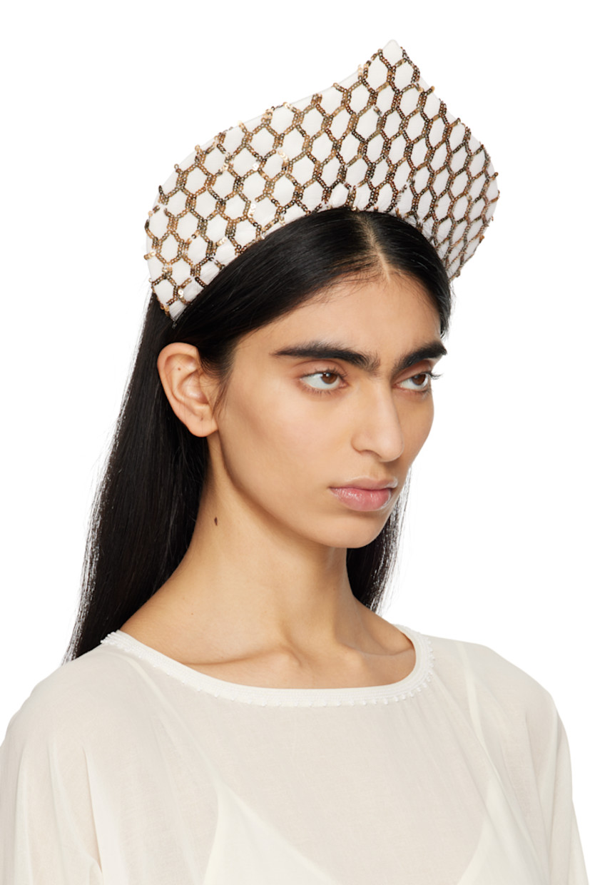 Satin and mesh headband in off-white and gold tone.

· Sequin throughout
· Elasticized band

Supplier color: Cream gold