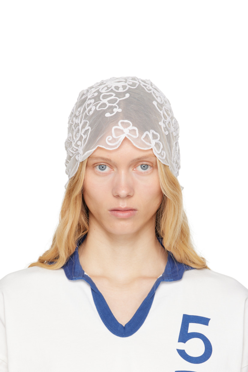Nylon mesh veil in white. 

· Floral pattern embroidered throughout
· Scalloped edges
· Velvet bow accent at back 
· H20.5" x W11" 

This item is part of a limited run of 16.

Supplier color: White/White