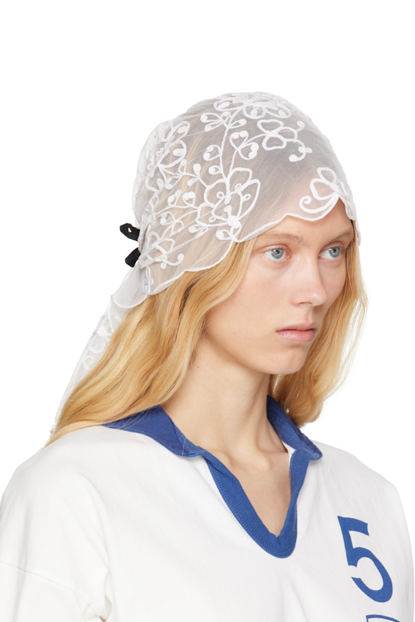 Nylon mesh veil in white. 

· Floral pattern embroidered throughout
· Scalloped edges
· Velvet bow accent at back 
· H20.5" x W11" 

This item is part of a limited run of 16.

Supplier color: White/White