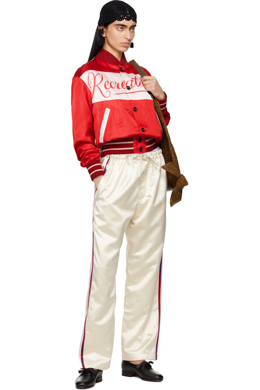 Polyester satin trousers. 

· Self-tie drawstring at waistband
· Three-pocket styling
· Button fly
· Striped trim at outseams and back pocket

This item is part of a limited run of 63.

Supplier color: Cream
