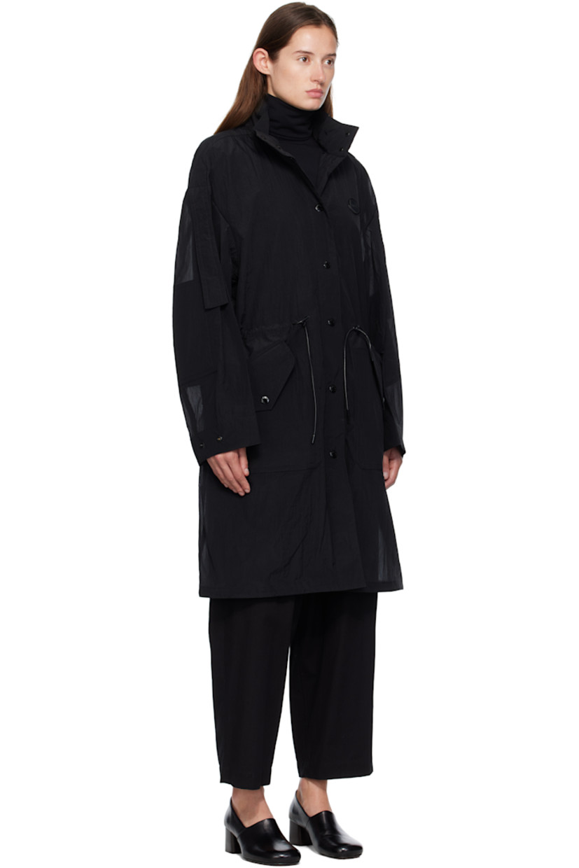 Nylon voile coat.

· Stand collar
· Press-stud closure
· Leather logo patch at chest
· Cord drawstring at waist and hem
· Press-stud flap pockets at front
· Extended trim at dropped shoulders
· Press-stud cuffs
· Central vent at back hem
· Unlined
· Logo-engraved black hardware

Part of the Moncler Genius x EE72 by Edward Enninful collaboration.

Supplier color: Black