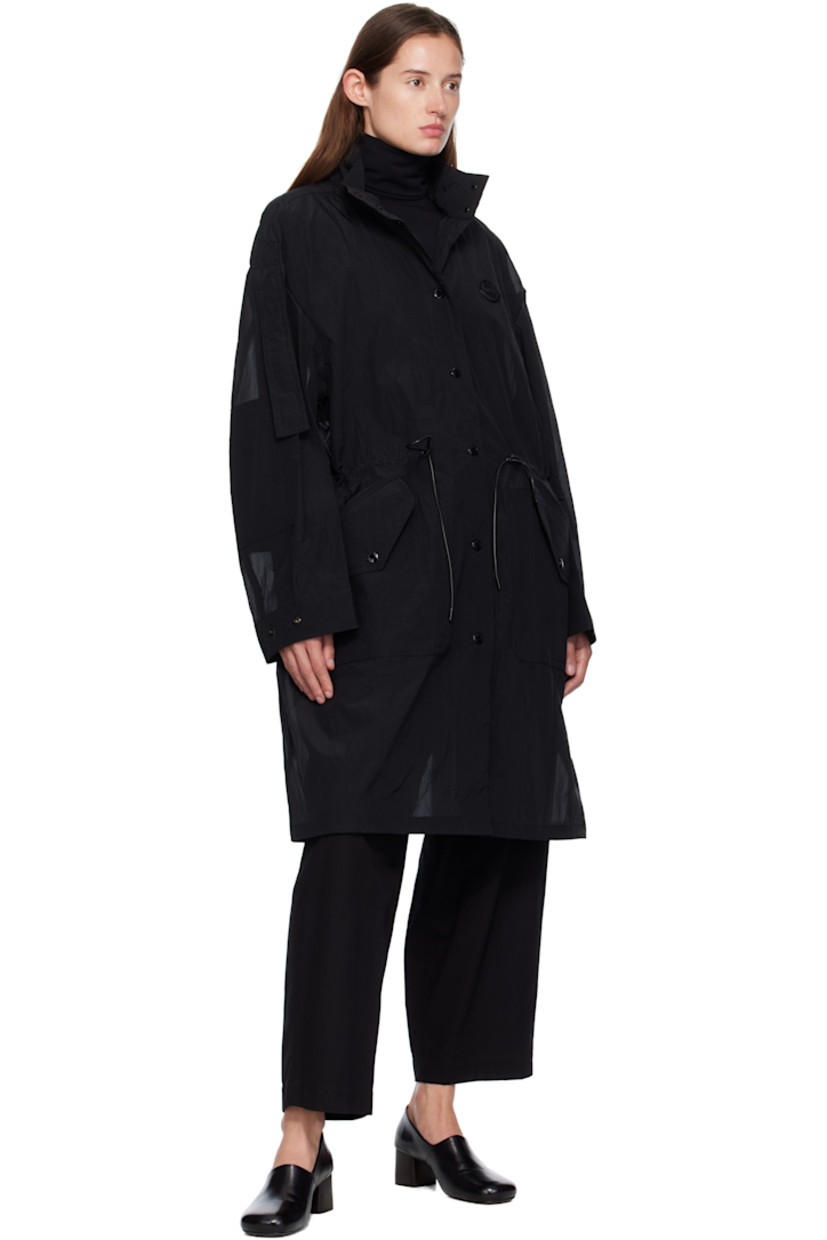 Nylon voile coat.

· Stand collar
· Press-stud closure
· Leather logo patch at chest
· Cord drawstring at waist and hem
· Press-stud flap pockets at front
· Extended trim at dropped shoulders
· Press-stud cuffs
· Central vent at back hem
· Unlined
· Logo-engraved black hardware

Part of the Moncler Genius x EE72 by Edward Enninful collaboration.

Supplier color: Black