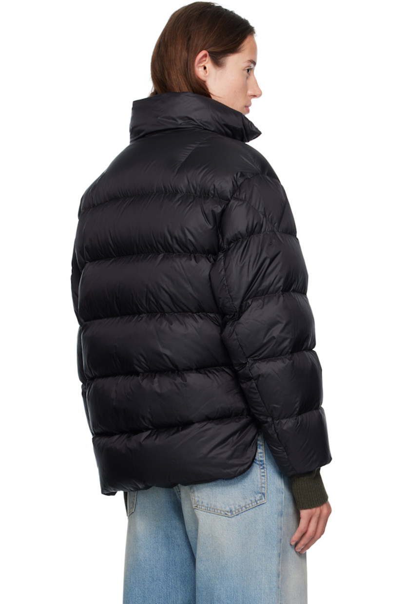 Quilted down-filled nylon taffeta jacket.

· DIST-certified down
· Funnel neck
· Two-way zip closure
· Flap pockets at waist
· Concealed bungee-style drawstring at cropped hem
· Rounded droptail hem
· Press-stud vent at side seams
· Leather logo patch at sleeve
· Elasticized cuffs
· Detachable webbing shoulder straps at interior
· Full nylon laqué lining
· Logo-engraved silver-tone hardware

Part of the Moncler Genius x EE72 by Edward Enninful collaboration.

Supplier color: Black

Fill: 90% goose down, 10% goose feather.