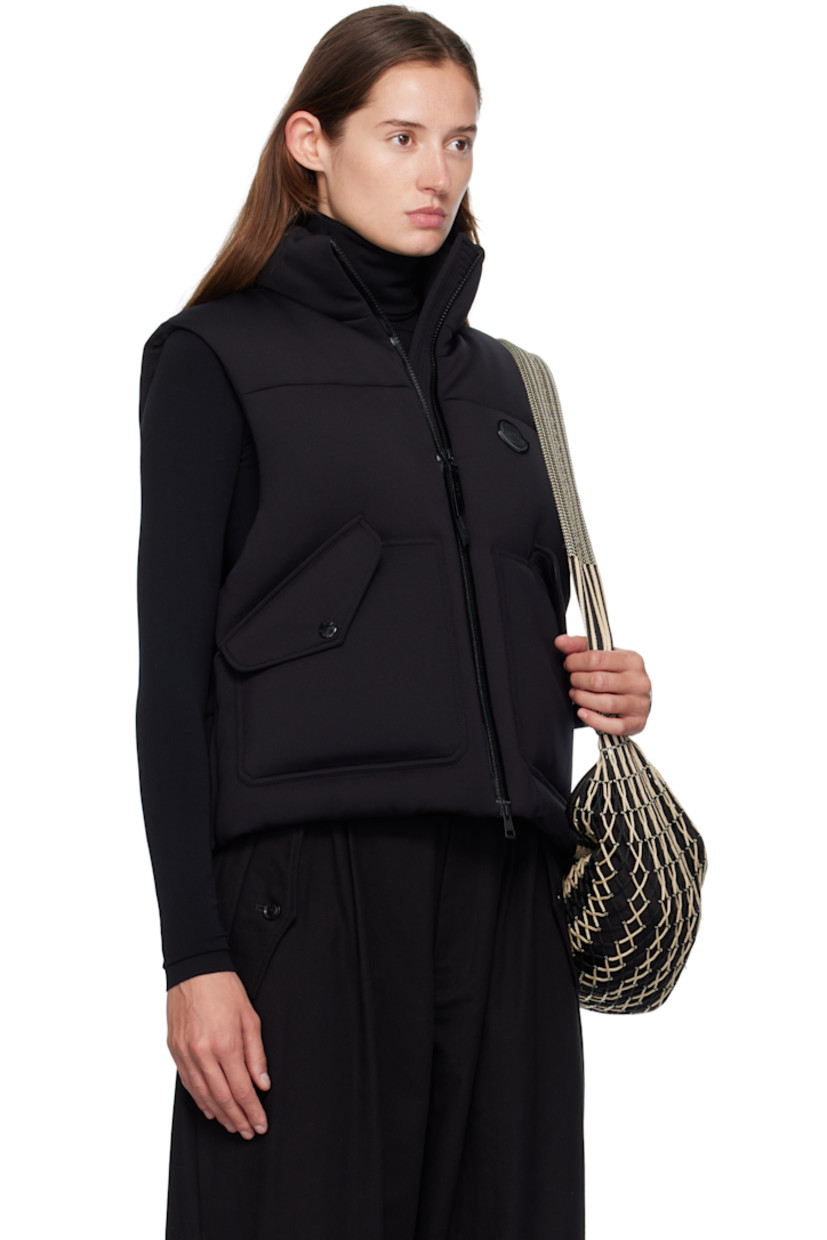 Quilted down-filled stretch nylon- and cotton-blend neoprene vest.

· DIST-certified down
· Funnel neck
· Two-way zip closure
· Leather logo patch at chest
· Flap pockets at waist
· Concealed bungee-style drawstring at hem
· Rounded droptail hem
· Press-stud vent at side seams
· Full nylon laqué lining
· Logo-engraved black hardware

Part of the Moncler Genius x EE72 by Edward Enninful collaboration.

Supplier color: Black

Fill: 90% goose down, 10% goose feather.