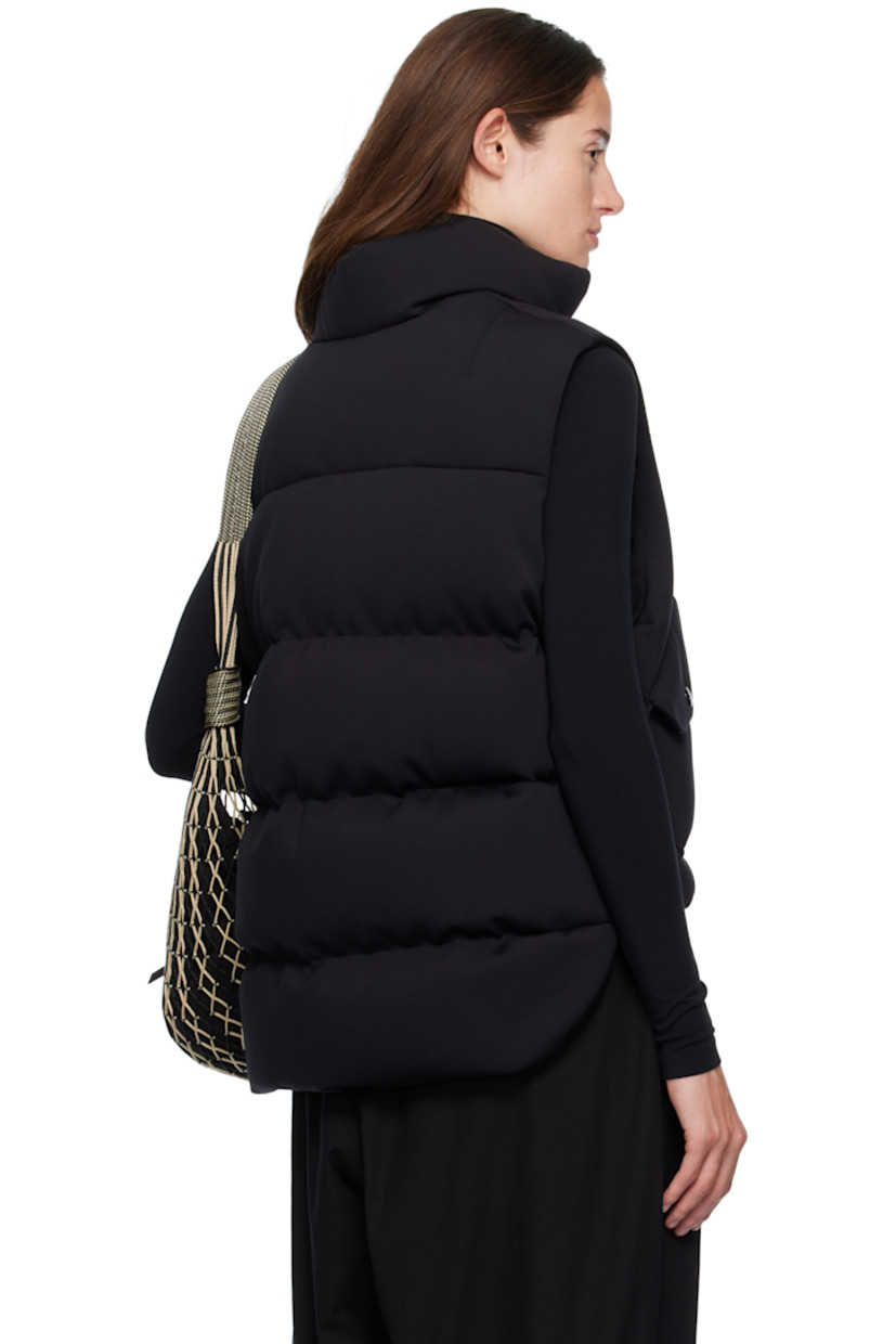Quilted down-filled stretch nylon- and cotton-blend neoprene vest.

· DIST-certified down
· Funnel neck
· Two-way zip closure
· Leather logo patch at chest
· Flap pockets at waist
· Concealed bungee-style drawstring at hem
· Rounded droptail hem
· Press-stud vent at side seams
· Full nylon laqué lining
· Logo-engraved black hardware

Part of the Moncler Genius x EE72 by Edward Enninful collaboration.

Supplier color: Black

Fill: 90% goose down, 10% goose feather.