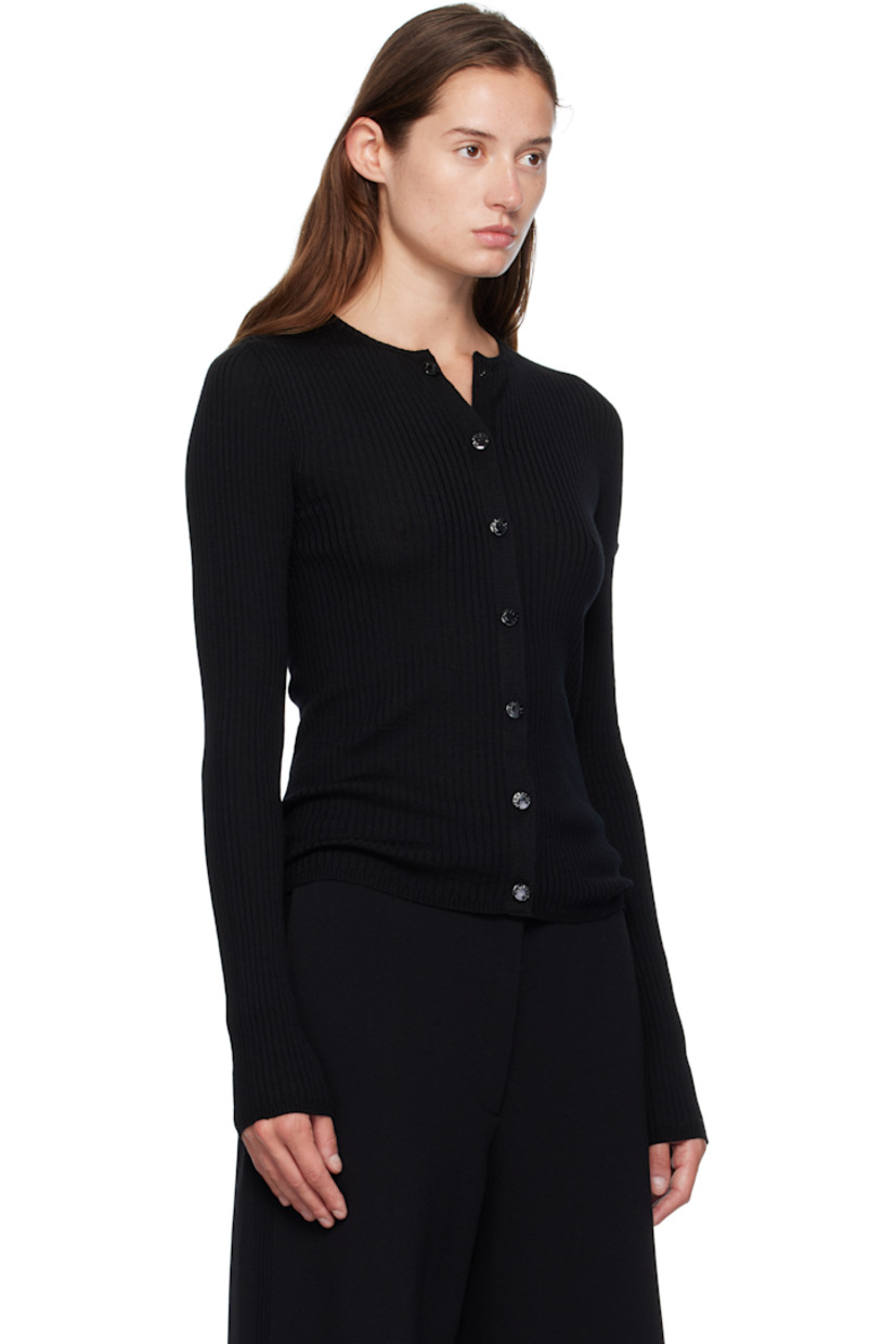 Rib-knit virgin wool cardigan.

· Crewneck
· Press-stud closure
· Leather logo patch at sleeve
· Logo-engraved black hardware

Part of the Moncler Genius x EE72 by Edward Enninful collaboration.

Supplier color: Black