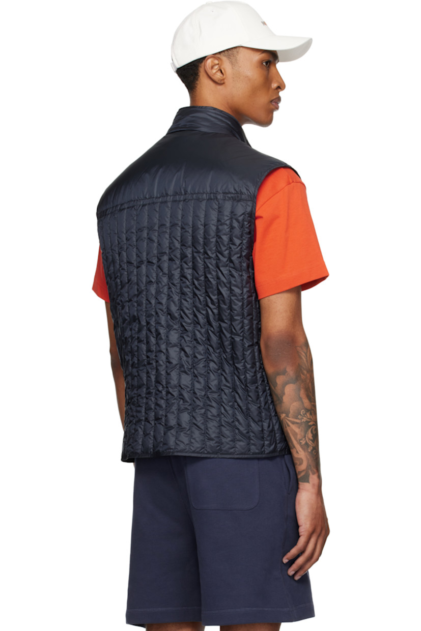 Down-filled and quilted nylon satin vest.

· DIST-certified down
· Stand collar
· Two-way zip closure
· Embroidered logo patch at chest
· Zip pockets
· Fully lined

Part of the Moncler Genius x Gilga Farm collaboration.

Supplier color: Dark navy blue

Fill 1: 90% goose down, 10% feather. Fill 2: 100% polyester.