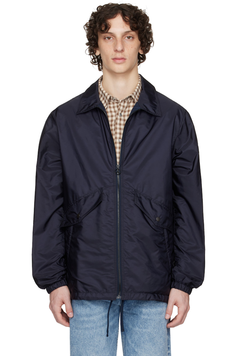 Nylon taffeta jacket.

· Zip closure
· Flap and welt pockets at front 
· Drawstring at hem 
· Felted logo patch with hardware at sleeve
· Elasticized cuffs
· Logo and graphic printed at back
· Full mesh lining

Part of the Moncler Genius x Mercedes-Benz by NIGO collaboration.

Supplier color: Dark navy blue