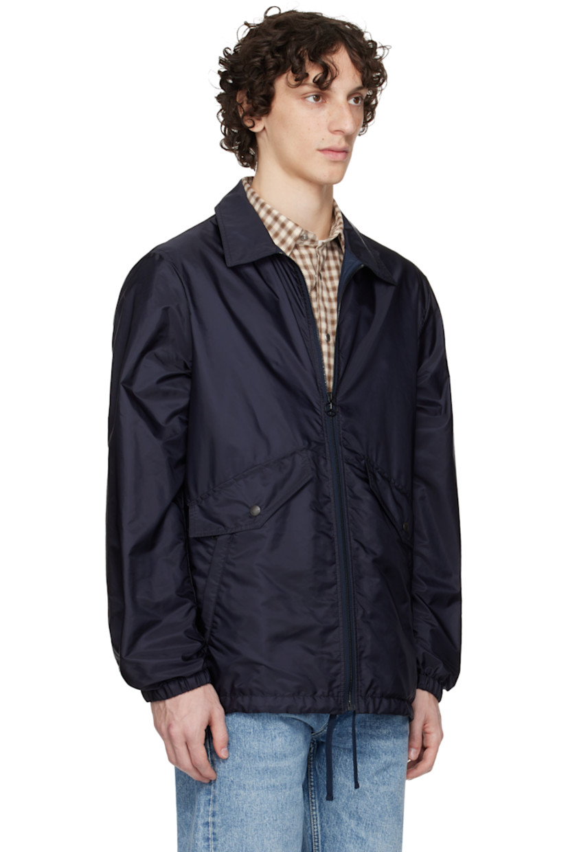Nylon taffeta jacket.

· Zip closure
· Flap and welt pockets at front 
· Drawstring at hem 
· Felted logo patch with hardware at sleeve
· Elasticized cuffs
· Logo and graphic printed at back
· Full mesh lining

Part of the Moncler Genius x Mercedes-Benz by NIGO collaboration.

Supplier color: Dark navy blue
