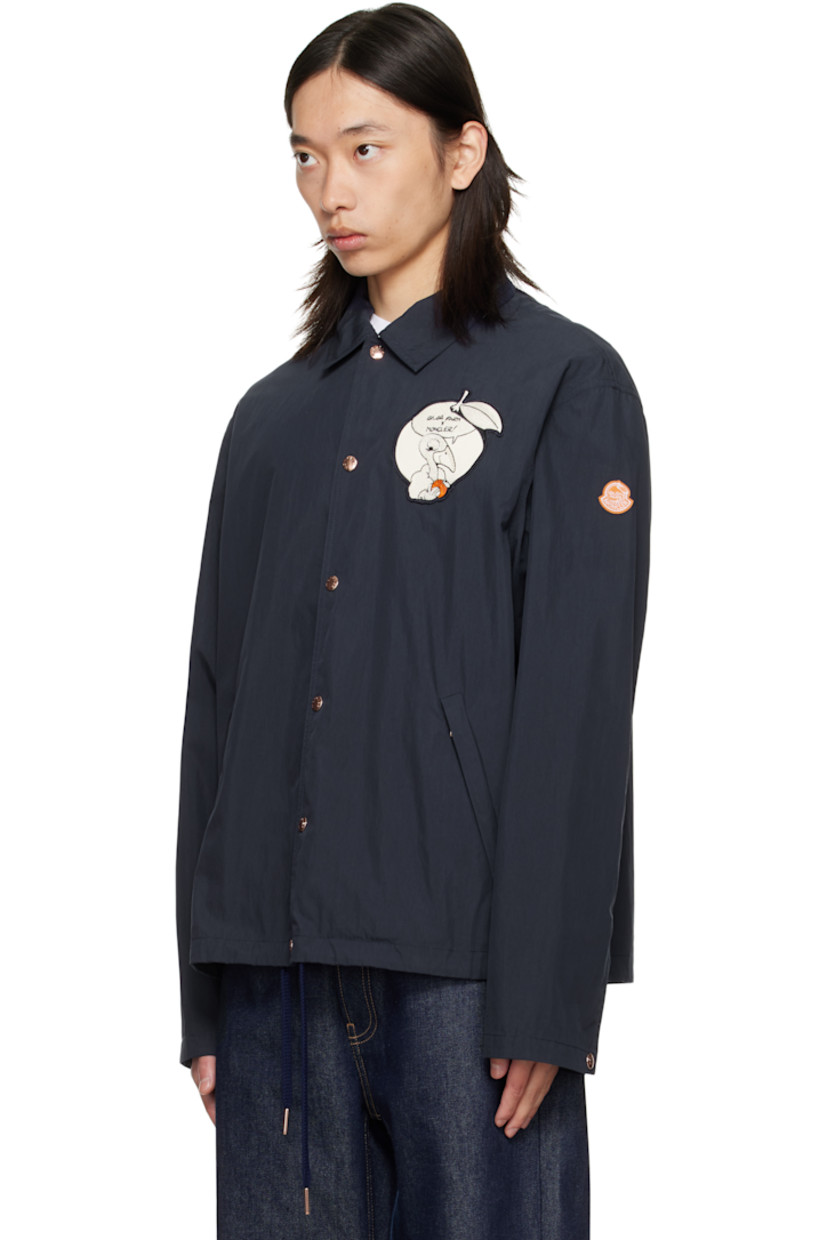 Crinkled cotton- and nylon-blend poplin jacket. 

· Spread collar
· Press-stud closure
· Embroidered graphic appliqué at chest and back
· Zip pockets at waist
· Embroidered logo patch at sleeve
· Press-stud cuffs
· Drawstring at hem
· Unlined

Part of the Moncler Genius x Gilga Farm by Donald Glover collaboration.

Supplier color: Starless Night