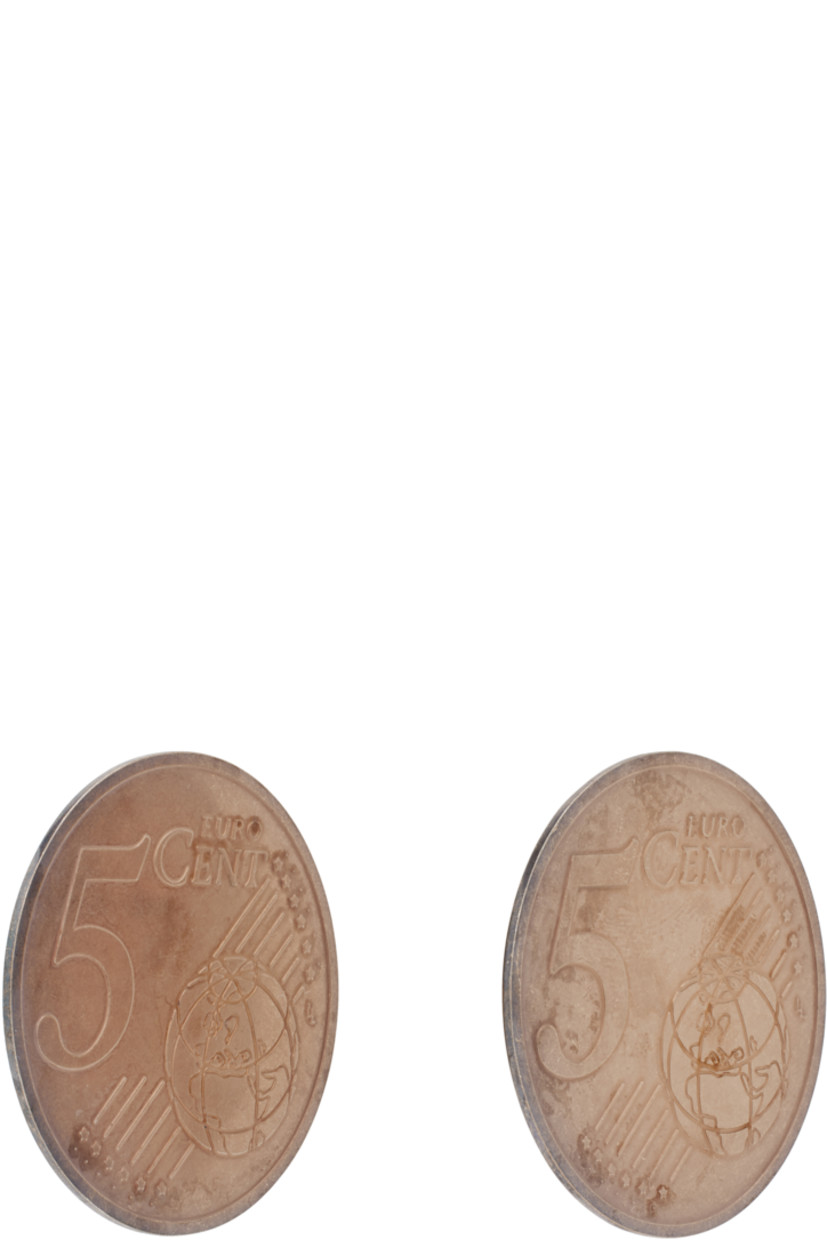 Pair of drop earrings in bronze-tone brass. 

· Text and graphic at face
· Logo engraved at back face
· Post-stud fastening 
· D2"

Part of the D'heygere x Vaquera collaboration. 

Supplier color: Copper