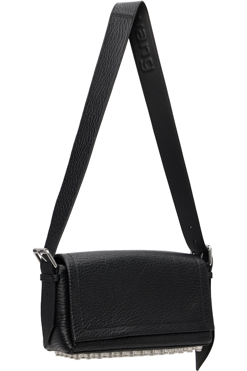 Grained lambskin shoulder bag.

· Adjustable and detachable shoulder strap
· Includes alternate crossbody strap
· Flat-head studs at base
· Flap closure with magnetic tab
· Phone slot, zip pocket, and card slot at interior
· Poplin lining
· H8" x W13" x D4.5"

Supplier color: Black