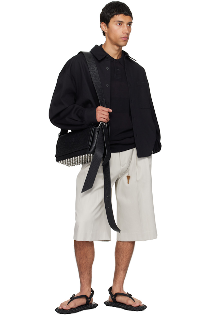 Grained lambskin shoulder bag.

· Adjustable and detachable shoulder strap
· Includes alternate crossbody strap
· Flat-head studs at base
· Flap closure with magnetic tab
· Phone slot, zip pocket, and card slot at interior
· Poplin lining
· H8" x W13" x D4.5"

Supplier color: Black