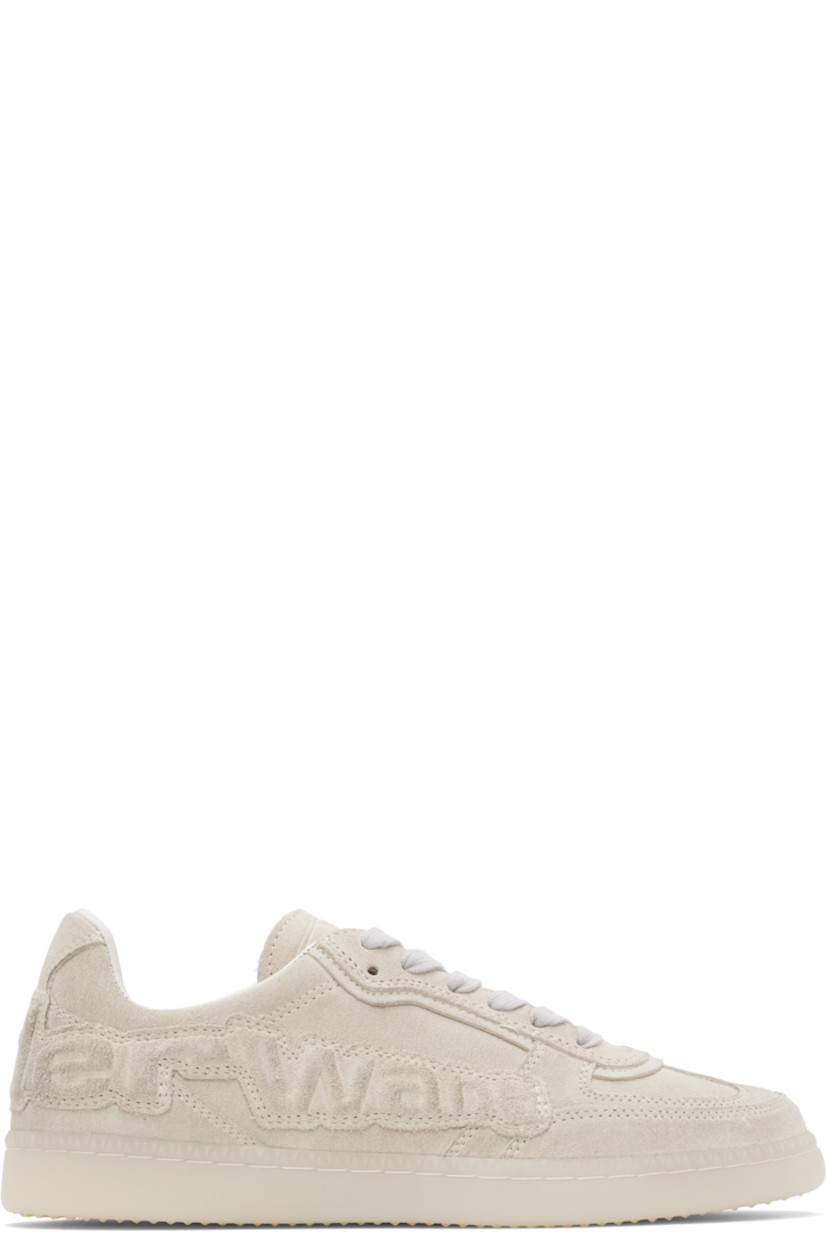 Low-top calfskin suede sneakers. 

· Lace-up closure
· Logo embossed at tongue
· Padded collar
· Embossed logo appliqué at sides and heel
· Buffed sheepskin lining
· Treaded rubber sole

Supplier color: Vintage white