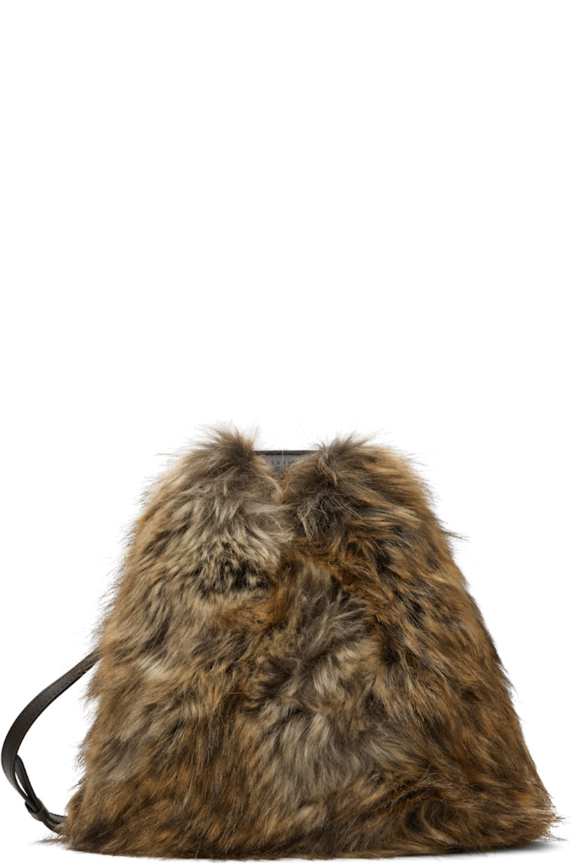 Faux-fur top handle bag.

· Logo-embossed rolled carry handle
· Adjustable shoulder strap
· Calfskin trim at base
· Press-stud fastening at throat
· Twill lining
· H10" x W10" x D5"

Supplier color: Curds/Whey