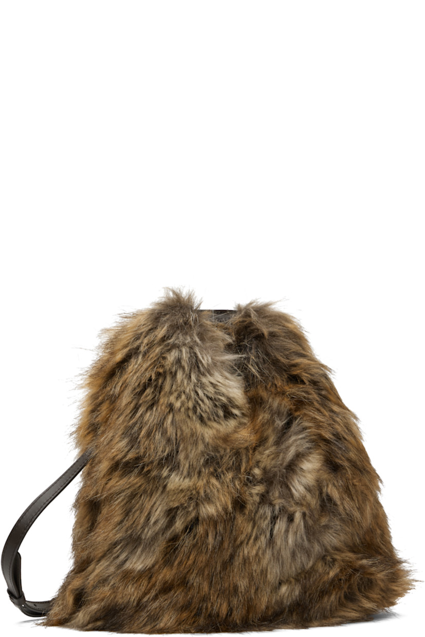Faux-fur top handle bag.

· Logo-embossed rolled carry handle
· Adjustable shoulder strap
· Calfskin trim at base
· Press-stud fastening at throat
· Twill lining
· H10" x W10" x D5"

Supplier color: Curds/Whey