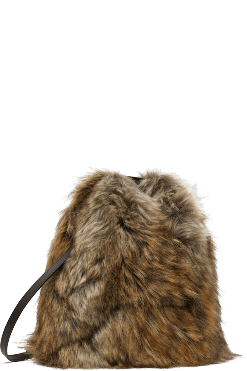 Faux-fur top handle bag.

· Logo-embossed rolled carry handle
· Adjustable shoulder strap
· Calfskin trim at base
· Press-stud fastening at throat
· Twill lining
· H10" x W10" x D5"

Supplier color: Curds/Whey