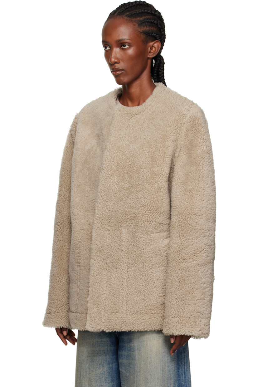 Cracked lambskin jacket.

· Shearling trim throughout
· Round neck
· Hook-eye closure
· Patch pockets at front
· White stitching at back collar
· Welt pockets at interior
· Shearling interior

Supplier color: Beige/Black