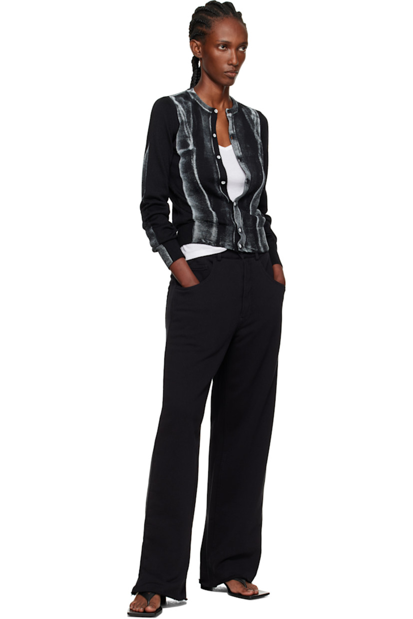 Knit virgin wool-blend cardigan.

· Rib-knit crewneck, hem, and cuffs
· Button closure
· Spray-dyed detailing at front and sleeves
· White stitching at back collar

Supplier color: Black