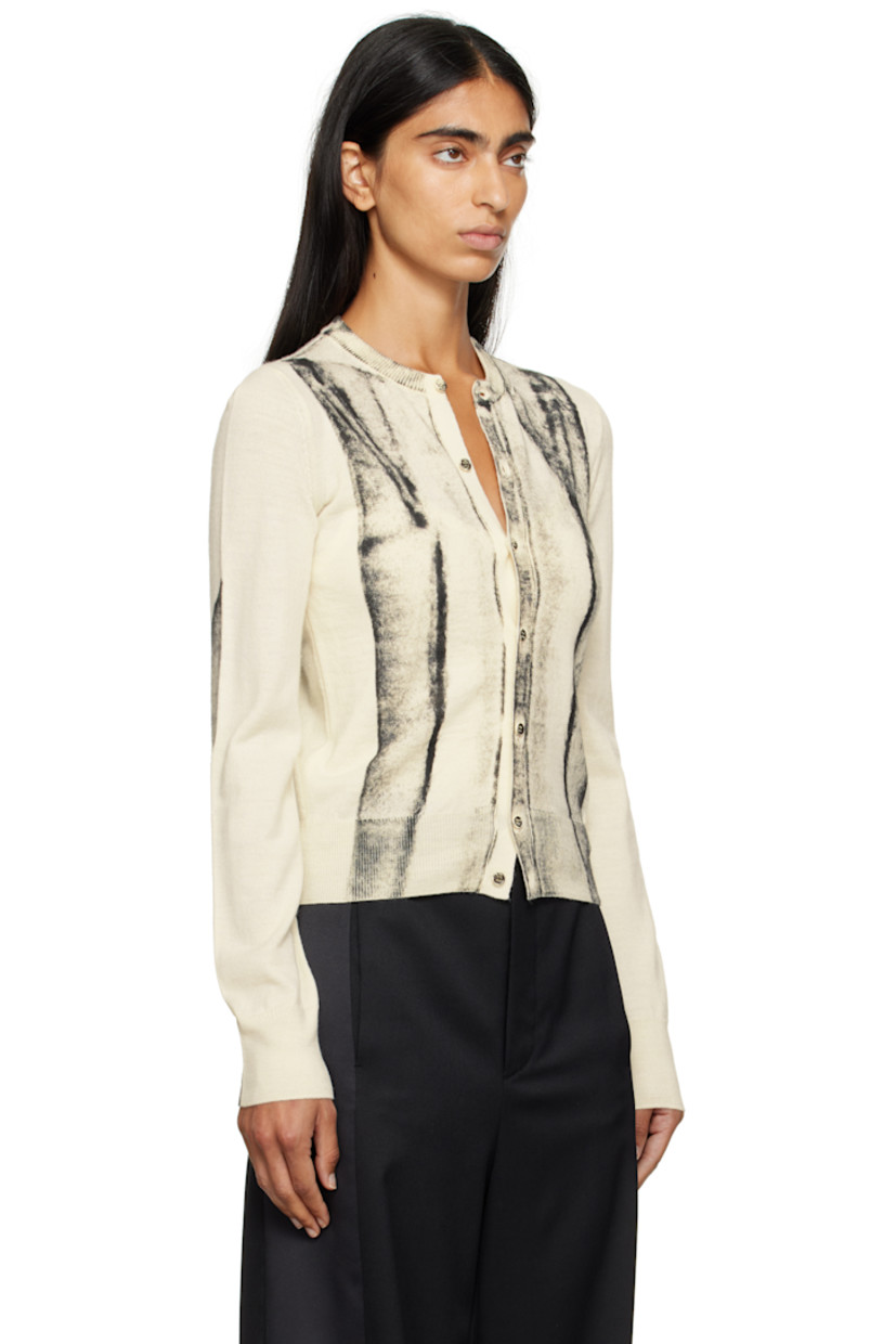 Knit virgin wool-blend cardigan.

· Rib-knit crewneck, hem, and cuffs
· Button closure
· Spray-dyed detailing at front and sleeves
· White stitching at back collar

Supplier color: Off white